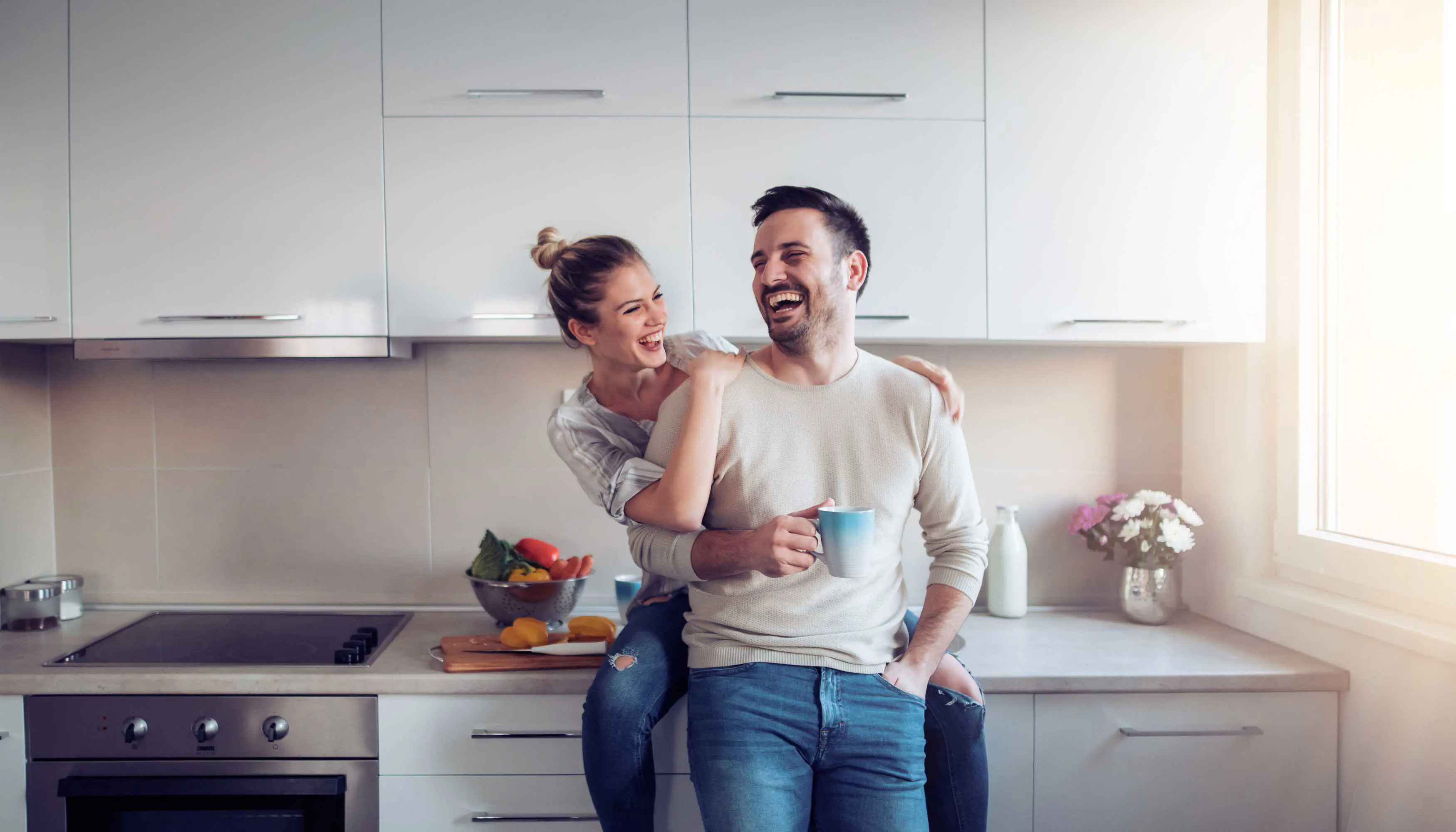 Happy couple in new kitchen and home